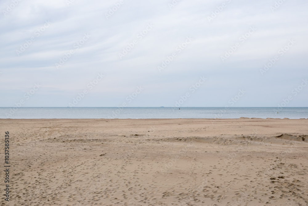Beach at sunset. Much sand, water and clouds. Beach at sunset. Much sand, water and clouds.