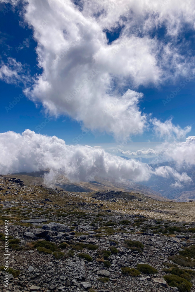 Cloudy over mountains on hiking trail to Mulhacen peak, Sierra Nevada National park, Andalusia, Spain Cloudy over mountains on hiking trail to Mulhacen peak, Sierra Nevada National park, Andalusia, Spain