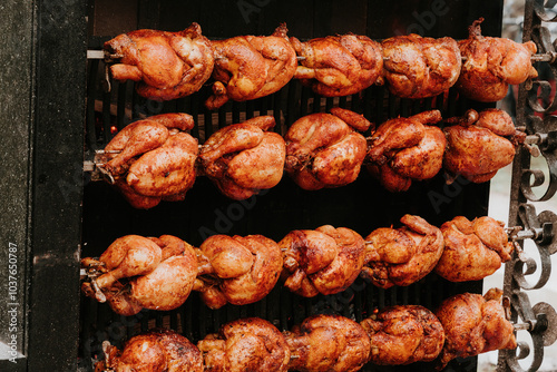 Multiple Roasted Chickens Slowly Turning On Outdoor Rotisserie