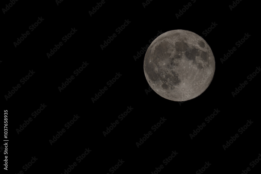 A high-resolution photograph of the full moon, capturing the intricate details of its surface against the dark night sky. A high-resolution photograph of the full moon, capturing the intricate details of its surface against the dark night sky.