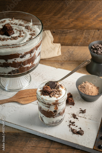 Canvas Print Chocolate brownie trifle bowl with ingredients on white tray in a rustic kitchen