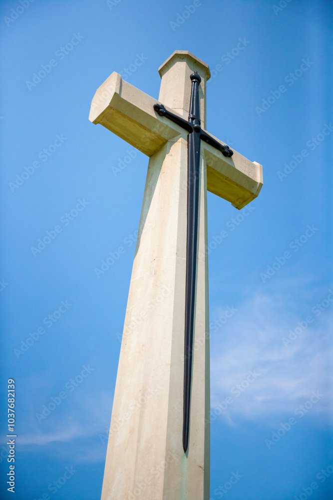 Large Christian cross against a bright blue sky at Kanchanaburi War Cemetery, Thailand Large Christian cross against a bright blue sky at Kanchanaburi War Cemetery, Thailand