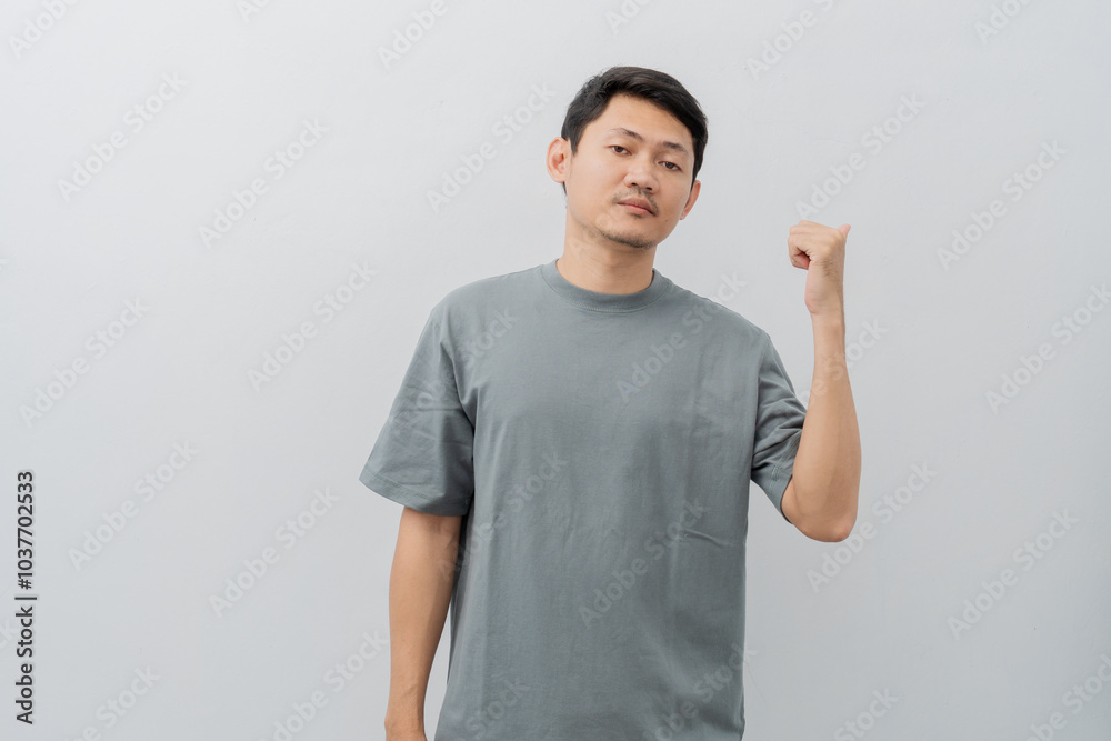 Sad and disappointed expression of adult Asian man pointing fingers with casual t-shirt isolated on white background Sad and disappointed expression of adult Asian man pointing fingers with casual t-shirt isolated on white background