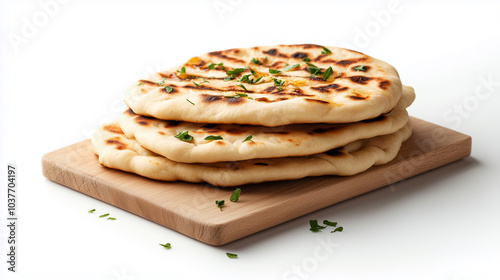 Freshly baked naan bread stacked on wooden board, garnished with herbs, showcasing golden brown crust and soft texture, perfect for any meal.