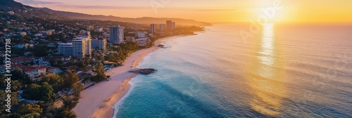 A stunning sunset illuminates a coastal city with waves gently lapping the sandy shore under a golden sky. photo