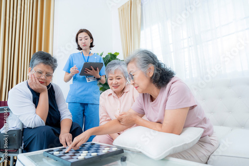 A group of elderly women enjoy a board game together, fostering social interaction and mental stimulation. A healthcare worker stands nearby, ensuring a supportive and healthy environment for senior.