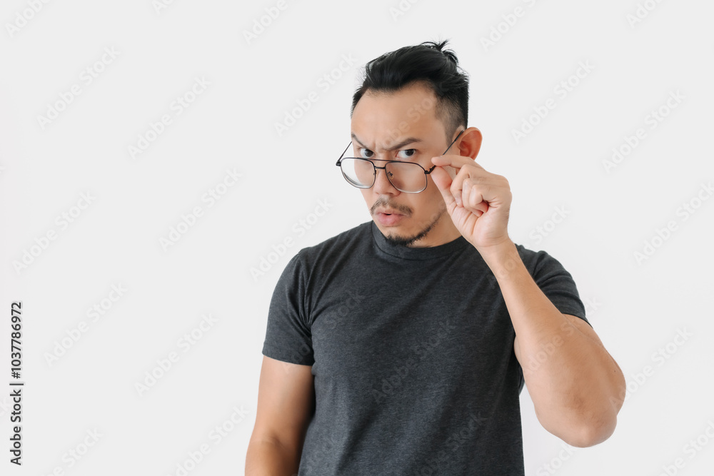 Serious angry face Asian freelance man bun hair in black on white. Serious angry face Asian freelance man bun hair in black on white.
