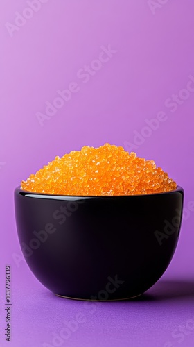 A tropical mango sugar scrub with bright orange sugar crystals and dried mango chunks on a vivid purple background, emphasizing its sweet mango scent and smooth exfoliating texture. photo