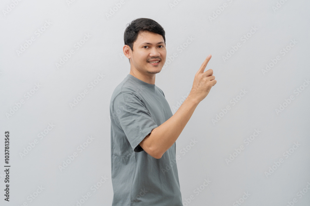 Happy expression of adult Asian man pointing fingers with casual t-shirt isolated on white background Happy expression of adult Asian man pointing fingers with casual t-shirt isolated on white background