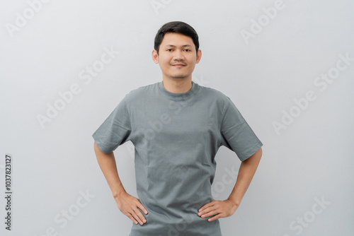 Happy expression of adult Asian man with casual t-shirt isolated on white background photo