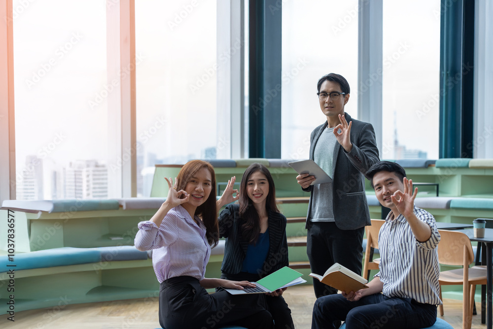 A group of Gen Z Asian business consulting, exchanging information in offices, co-working spaces. A group of Gen Z Asian business consulting, exchanging information in offices, co-working spaces.