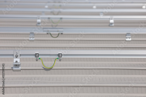 Grounding system connection of two rail sections by ground bar lug. Grounding system connection to equalize potential of the rails supporting the solar panels. photo