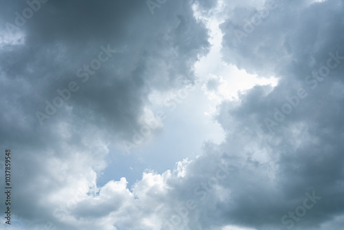 Dramatic timelapse of white clouds racing across a blue sky, casting dark shadows on the landscape