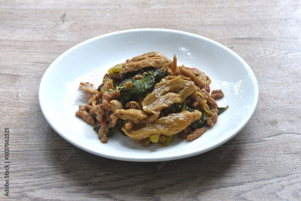 spicy stir fried chop gluten protein with basil dressing slice chili vegetarian fusion food on plate spicy stir fried chop gluten protein with basil dressing slice chili vegetarian fusion food on plate