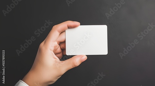 Female hand hold a white blank credit card for mockup. Modern way of banking and buying. photo