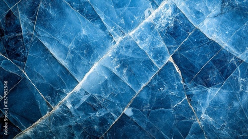 A close-up view of a blue mineral with translucent layers and intricate patterns.