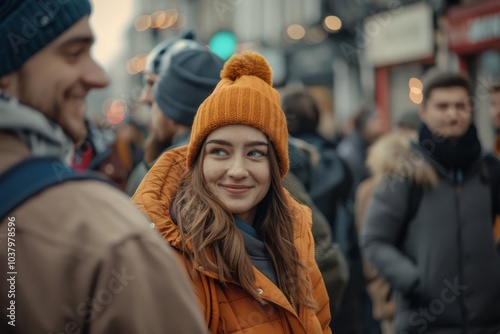 Beautiful young woman in a hat and coat on the street.