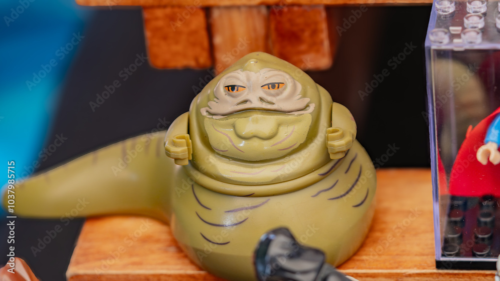 Fototapeta premium Budokan Geek Convention In GUAYAQUIL, ECUADOR - OCT 13, 2024 - Jabba the Hutt Lego minifigure displayed at a toy collection event, showcasing Star Wars characters. Jabba the Hutt Lego Minifigure