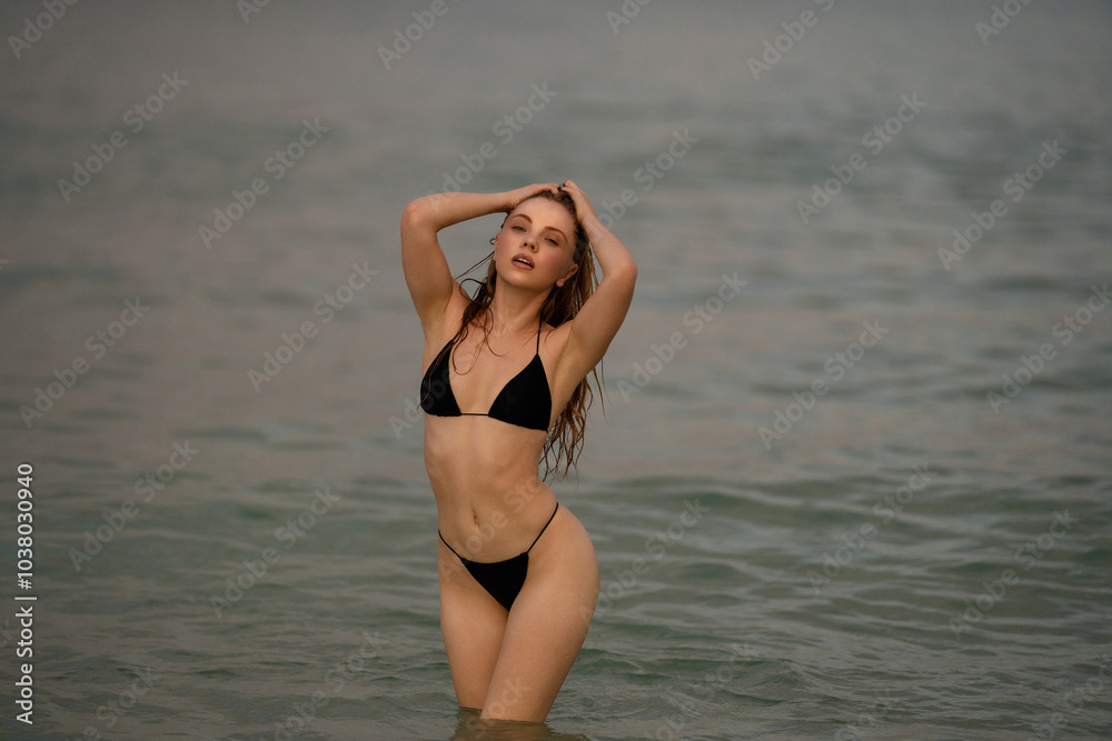 Young woman in bikini on summer beach. Sexy woman enjoying summer at sea. Beautiful girl in a sexy bikini on the beach. Slim female model posing in swimsuit on the sea shore. Young woman in bikini on summer beach. Sexy woman enjoying summer at sea. Beautiful girl in a sexy bikini on the beach. Slim female model posing in swimsuit on the sea shore.