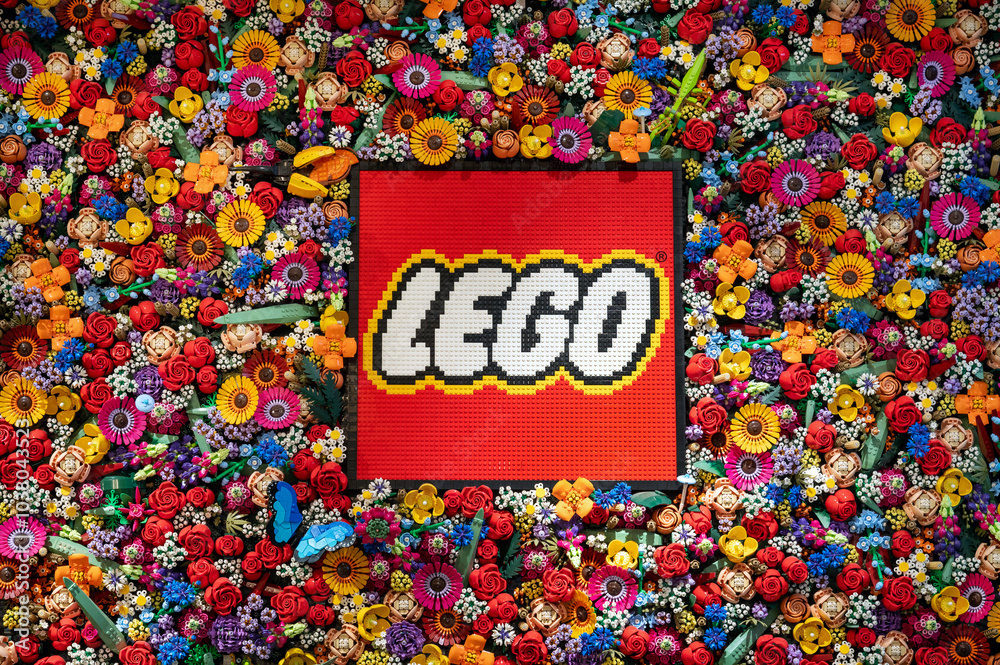 Obraz premium Lego logo made with colorful bricks surrounded by lego flowers