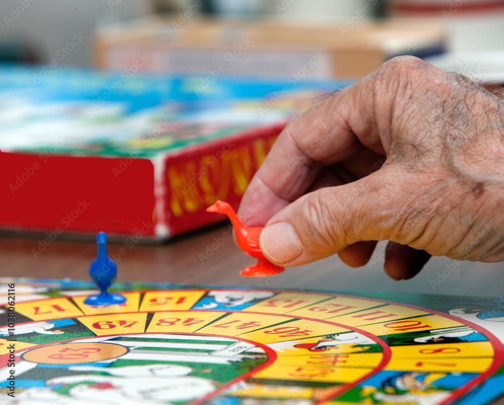 Playing a game of the goose. Elderly care. Playing a game of the goose. Elderly care.