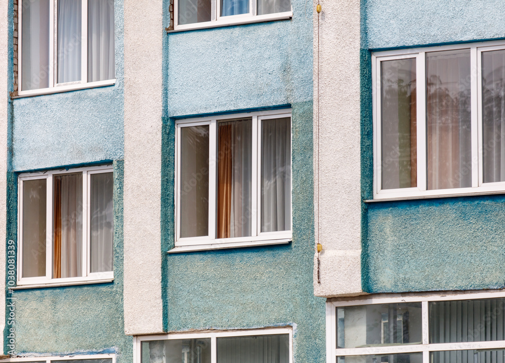 A blue and white building with many windows A blue and white building with many windows