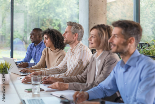 Image of row of business people working at seminar