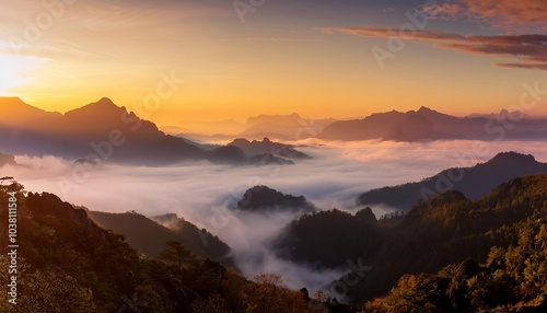 Majestic mountain ranges forming misty landscape at sunrise