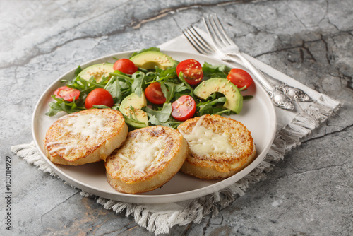 Baked eggy crumpets and salad perfect for breakfast closeup on the plate on the table. Horizontal