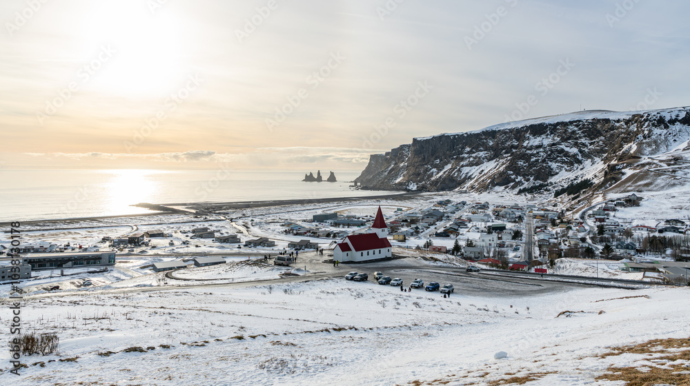 High angle view of Vík í Mýrdal at the south coast of Iceland, Church build on a small hill, village and volcanic cliffs High angle view of Vík í Mýrdal at the south coast of Iceland, Church build on a small hill, village and volcanic cliffs