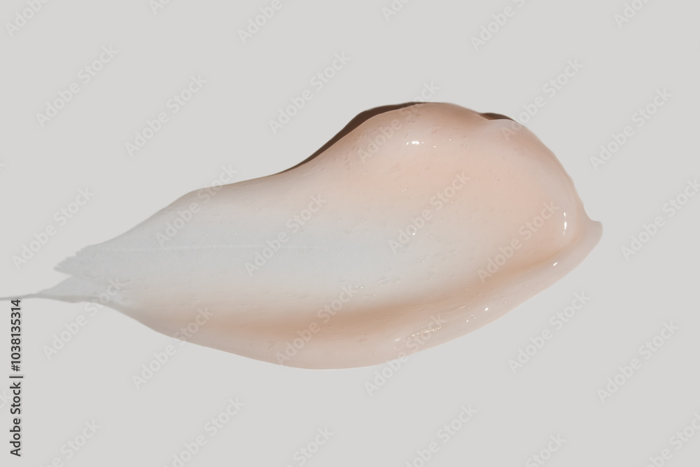 Fototapeta premium Texture of pink cream on white background. Smear of moisturizer close up. Lotion swatch. Beauty skin care product smear smudge. SPF sunscreen cream sample on color background
