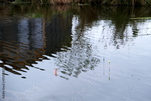 floats on the water, the house is reflected in the ripples of the water, fishing