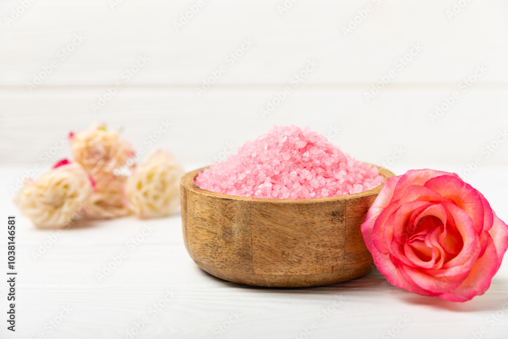 Sea salt for bath with aroma and rose flowers on textured wooden background. Pink sea salt. Spa treatments. Natural salt with herbs and essential oils. skincare concept. Meso for text. Copy space Sea salt for bath with aroma and rose flowers on textured wooden background. Pink sea salt. Spa treatments. Natural salt with herbs and essential oils. skincare concept. Meso for text. Copy space