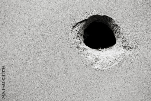 Cracks holes on the cement wall Caused by drilling To put the plumbing tube in the house