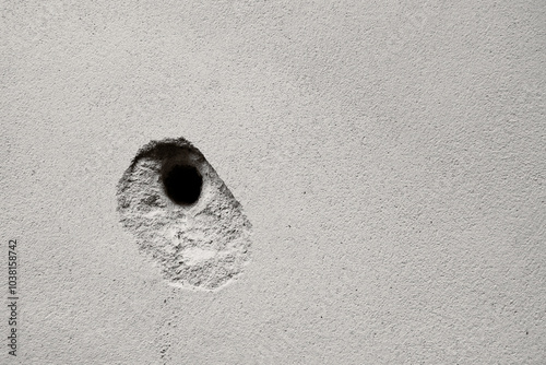 Cracks holes on the cement wall Caused by drilling To put the plumbing tube in the house