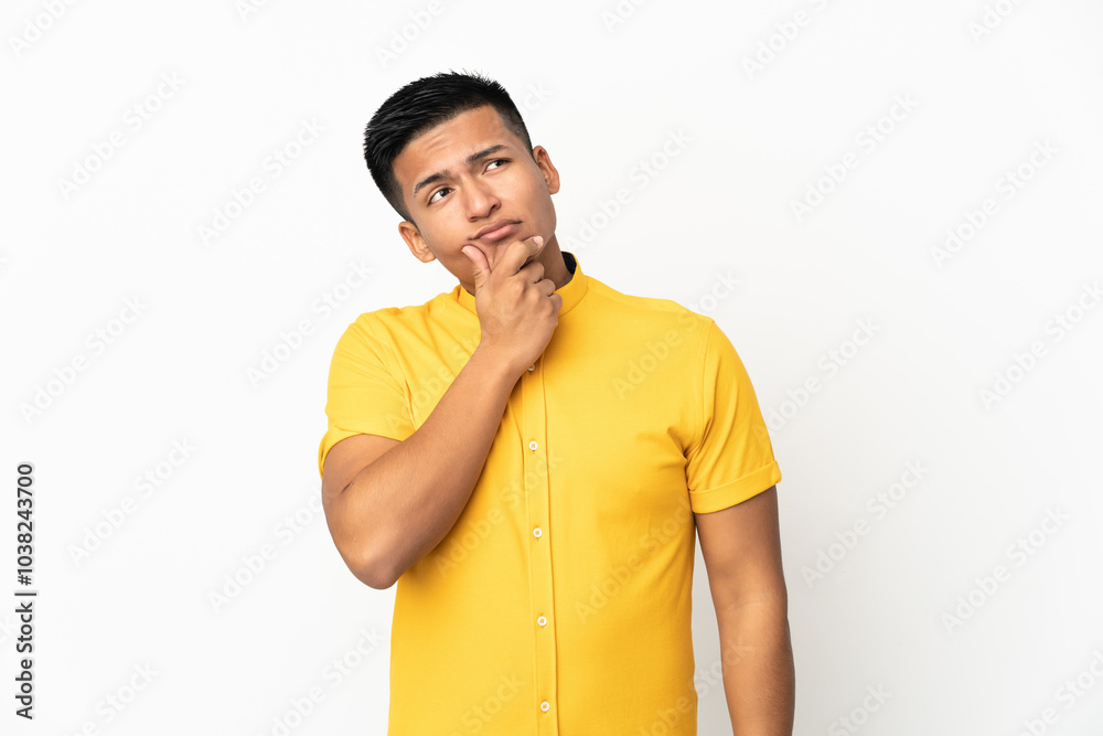 Young Ecuadorian man isolated on white background having doubts Young Ecuadorian man isolated on white background having doubts