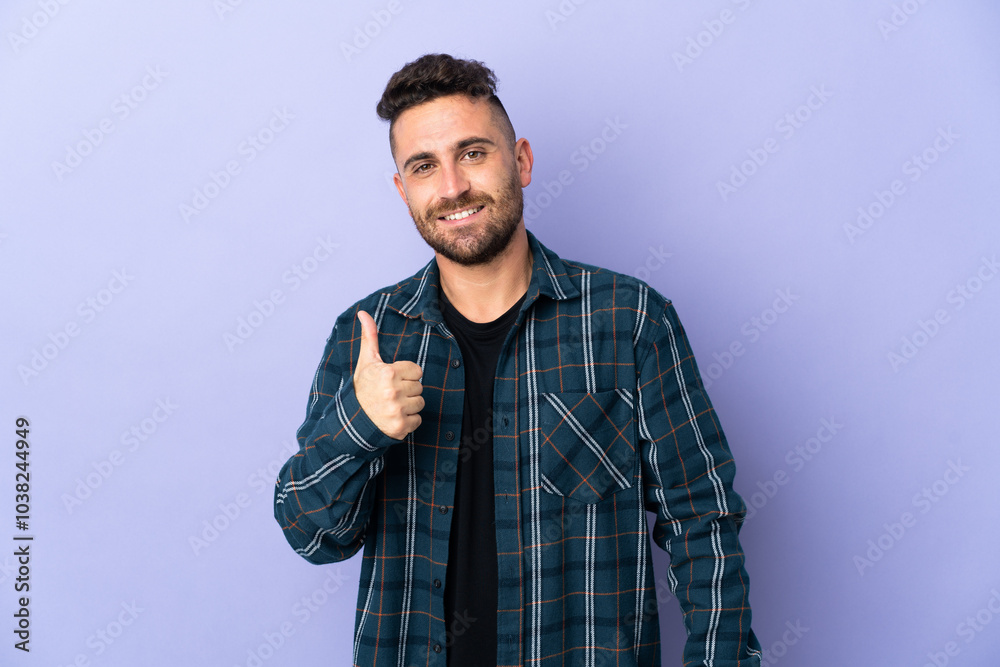 Caucasian man isolated on purple background giving a thumbs up gesture