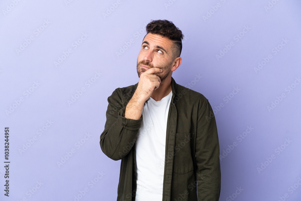 Caucasian man isolated on purple background having doubts Caucasian man isolated on purple background having doubts