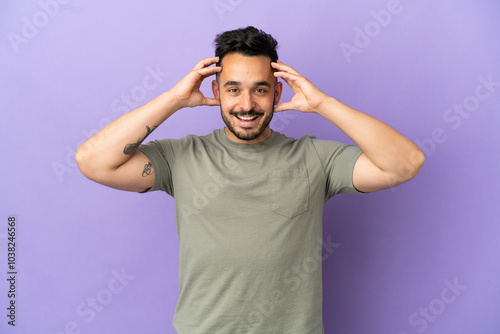 Young caucasian man isolated on purple background with surprise expression