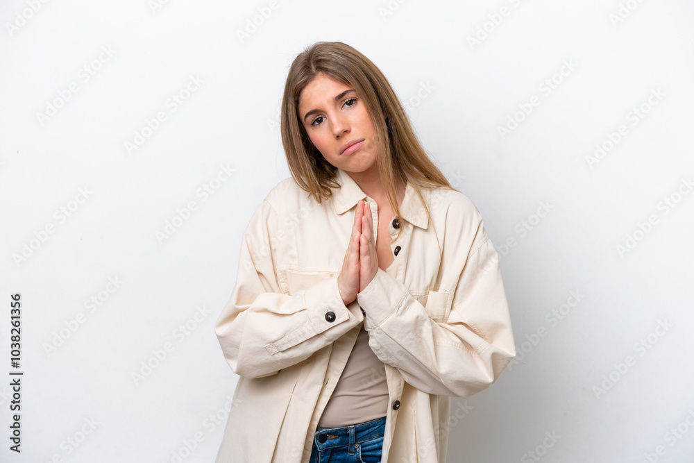 Young caucasian woman isolated on white bakcground keeps palm together. Person asks for something Young caucasian woman isolated on white bakcground keeps palm together. Person asks for something