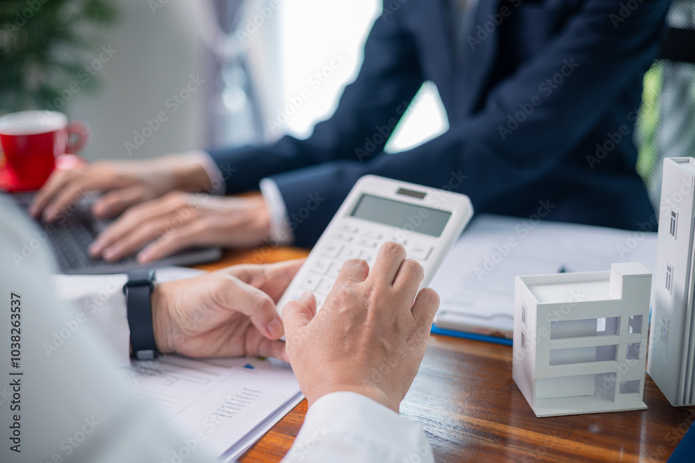 Real estate agent guided adult customers, both males and females, through business of property investment, highlighting finance and economy aspects for people interested in real estate market. Real estate agent guided adult customers, both males and females, through business of property investment, highlighting finance and economy aspects for people interested in real estate market.