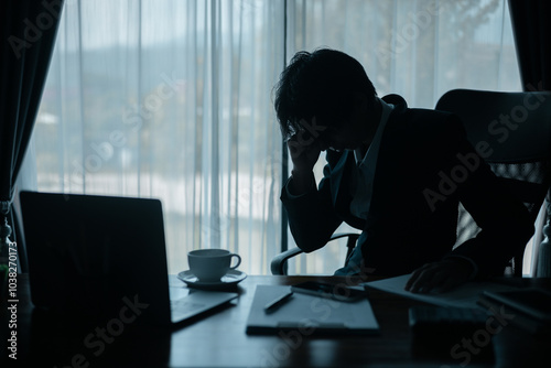 Stressed businessman, sleepy man working in his office, sat at his computer, feeling weight of his job and the demands of his business. person, work, business, stressed, sleepy, office, computer, job.