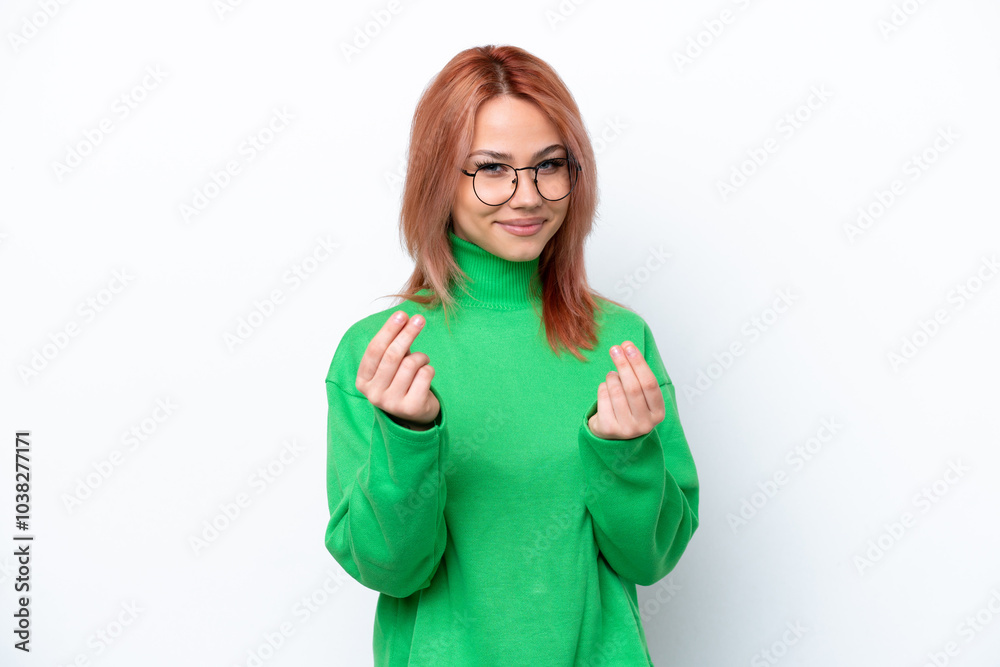 Fototapeta premium Young Russian girl isolated on white background making money gesture