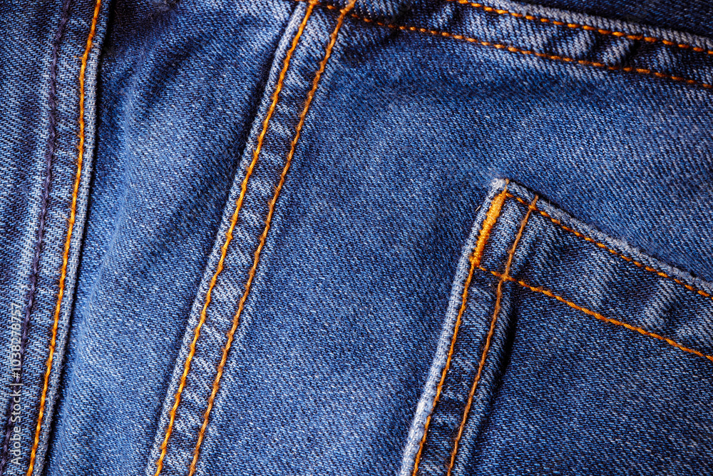 Worn denim trousers. Machine stitch close up. Denim texture in blue. The concept of repairing old clothes. Sewing factory. Fashionable aging clothes. Worn denim trousers. Machine stitch close up. Denim texture in blue. The concept of repairing old clothes. Sewing factory. Fashionable aging clothes.