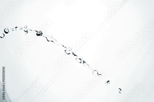Water splash isolated on blue background. Transparent realistic water with movement and drops. Dynamic flight of water drops.