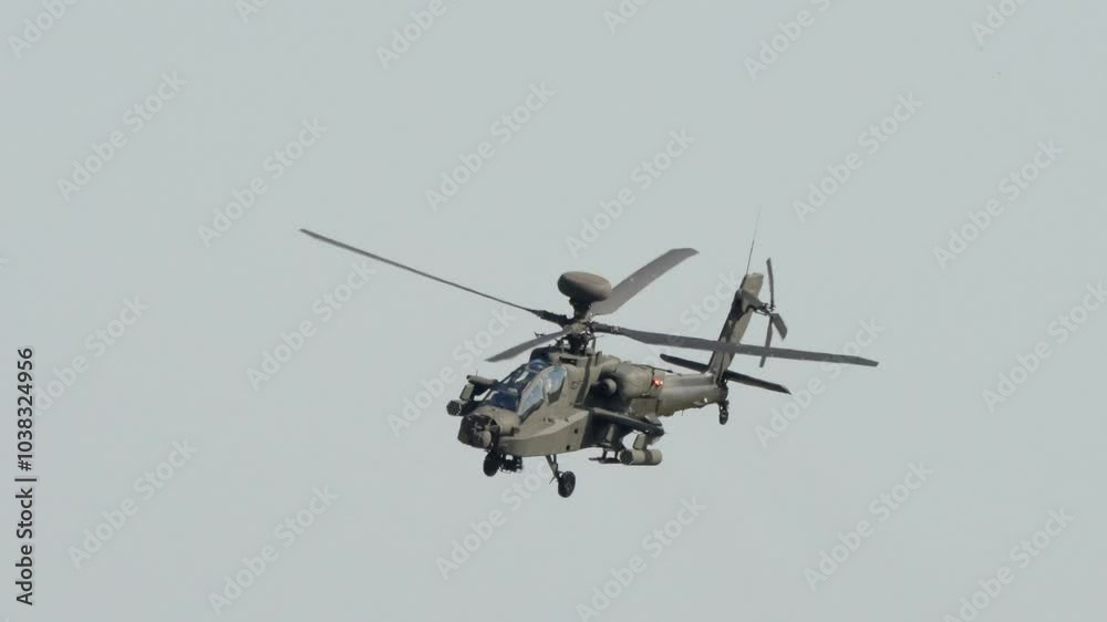 British army Boeing Apache Attack helicopter gunship AH2 AH64E AH-64E Army Air Corps in low level hover and flight, Wiltshire UK British army Boeing Apache Attack helicopter gunship AH2 AH64E AH-64E Army Air Corps in low level hover and flight, Wiltshire UK