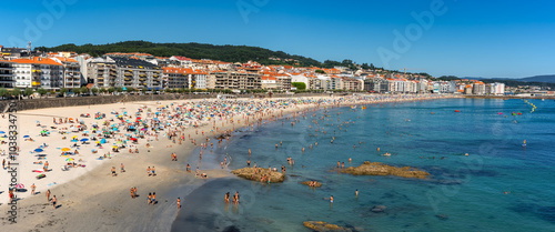 Sanjenjo, Spain, August 15, 2024: Silgar Beach packed with tourists on a sunny day in the Ria de Pontevedra, Galicia.