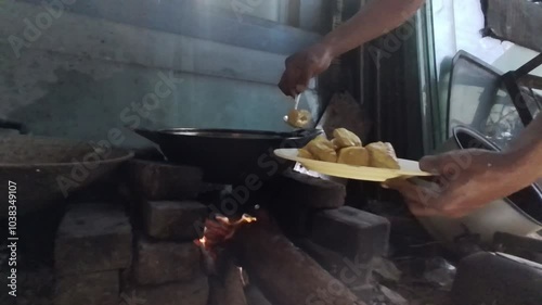 Traditional cooking stove with raw materials using dry wood and bamboo. metal for heating water, cooking or boiling over a fire in a rustic wood stove. Concept, winter, cold, cozy, vintage,old kitchen