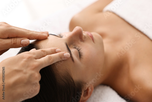 Attractive woman enjoying face massage, closeup. Beauty procedure