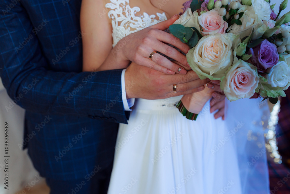 Wedding bouquet in the hands of the bride at the ceremony. Touching the hands of the bride and groom. Wedding jewelry. Wedding rings. The tenderness and beauty of the wedding ceremony. Wedding bouquet in the hands of the bride at the ceremony. Touching the hands of the bride and groom. Wedding jewelry. Wedding rings. The tenderness and beauty of the wedding ceremony.